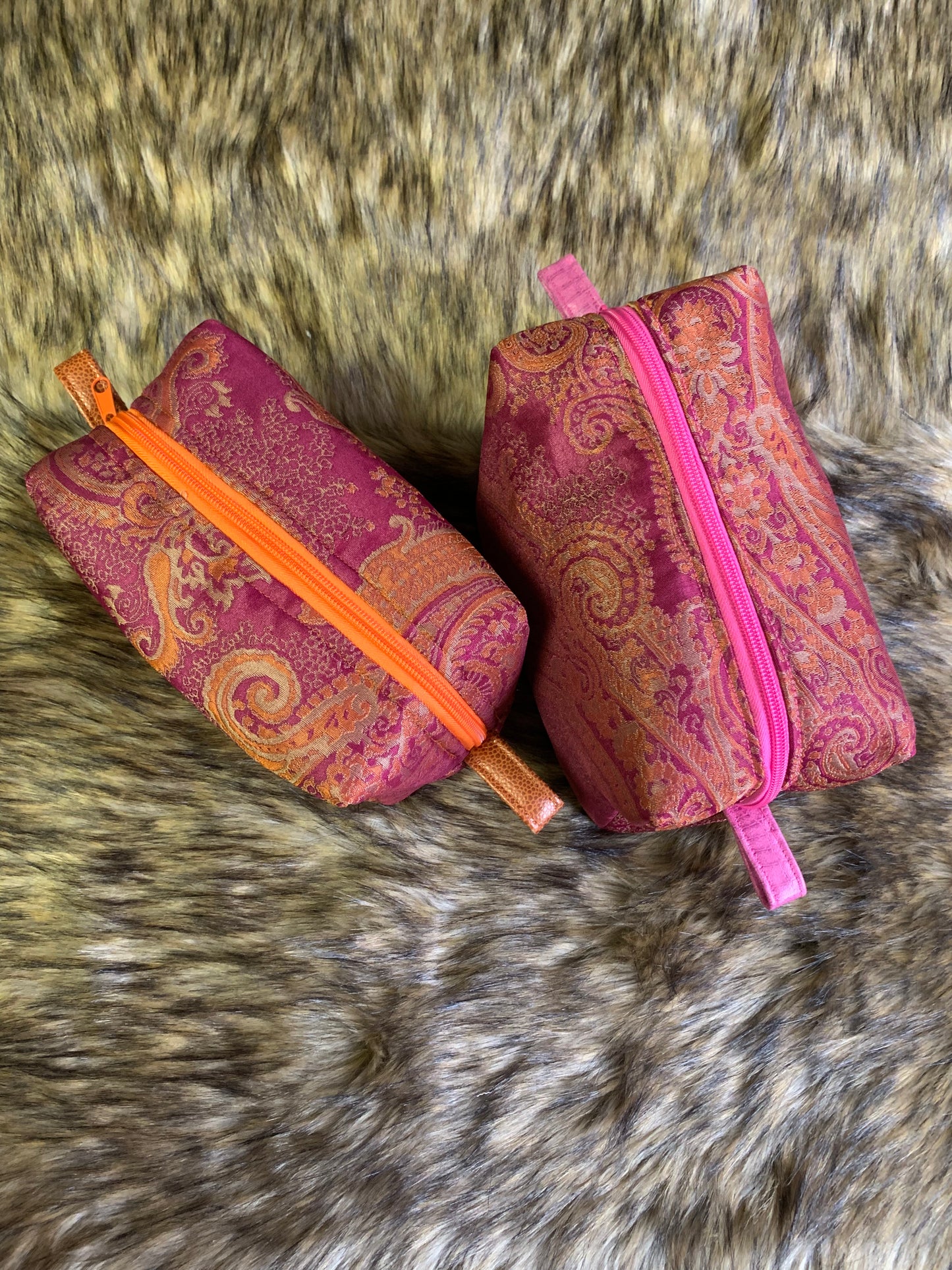Paisley print is timeless and this colourful fabric just makes anyone smile. Playful zippers in either mandarin orange or bright pink with matching thumb handles. Nesting essentials toiletry cosmetic bag Cherry zipper slightly larger. Orange zipper 1" smaller. 100% cotton lined. Bright and cheery.