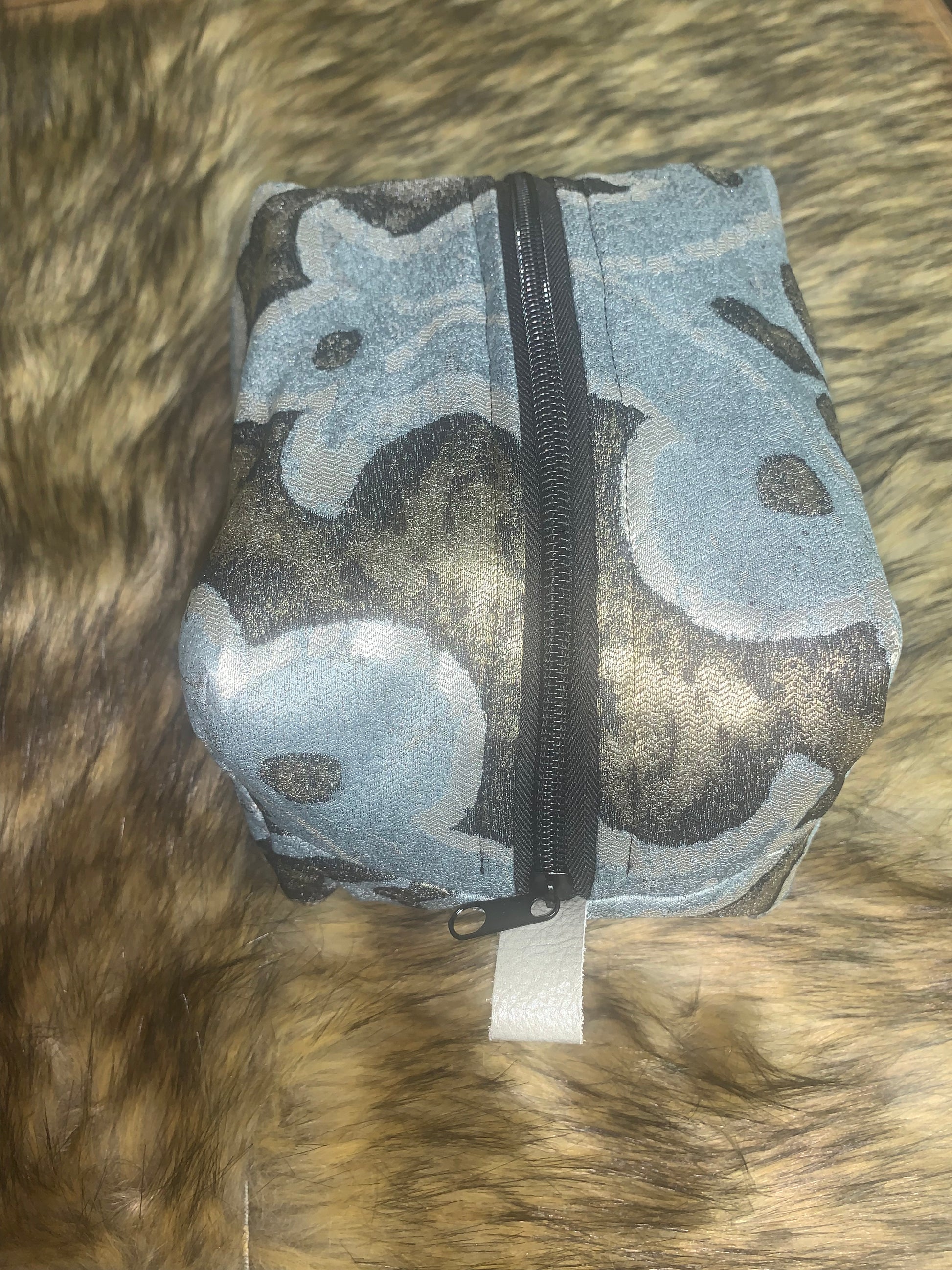 Nest all of your precious essentials together with elegance. This fabric is charcoal and silver with a roman Corinthian pattern in soft blue, as unique as each day. Each Nesting Essentials is fully lined and padded with unbleached 100% cotton. Hand wash as needed. Make caring for your personal self a glamorous affair.